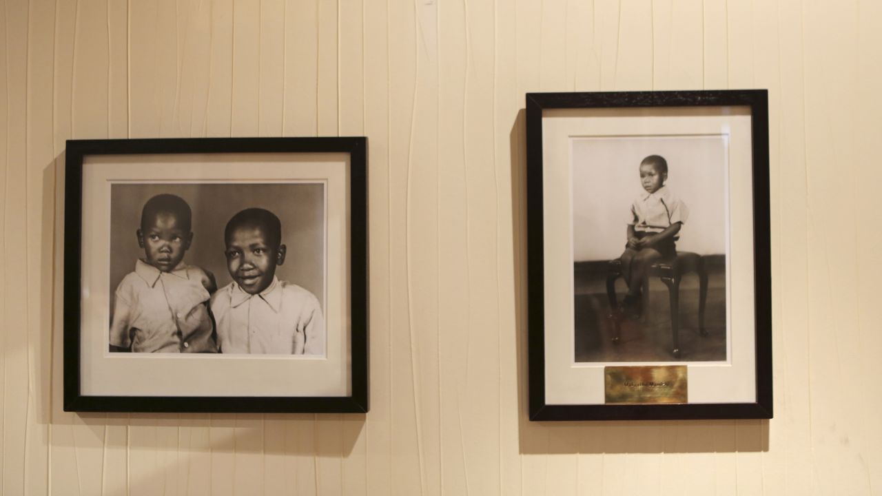 Pictures of the late sons of Nelson Mandela, by photographer Eli Weinberg, hang in his office at the Nelson Mandela Centre of Memory in Houghton, Johannesburg, on Tuesday, June 11.  Thembekile Mandela died in a 1969 car accident and Makgatho Mandela died from AIDS in 2005.