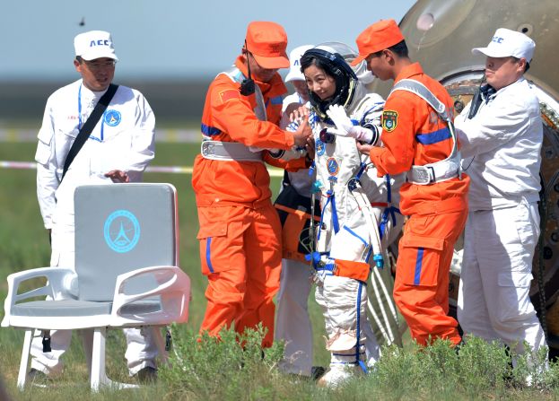 Wang Yaping (3rd R) is supported as she exits the spacecraft.  The successful mission was a major step toward China's goal of building a permanent space station by 2020. 