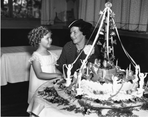 Shirley Temple celebrates her birthday in 1936 with her mother, Gertrude Temple. Her mother, recognizing her daughter's "it" factor, enrolled Shirley in dance classes at age 3. She landed her first film contract at the same age, and soon became one of the earliest and most successful child stars. The actress, now 85, went on to become a U.S. diplomat for the United Nations.