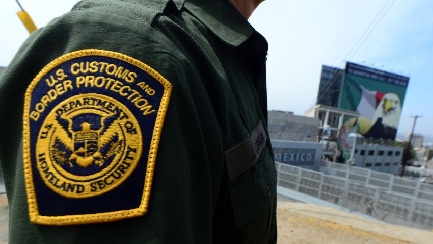 A U.S. Border Patrol agent stands near a crossing into Mexico at the San Ysidro port of entry in San Diego, California.