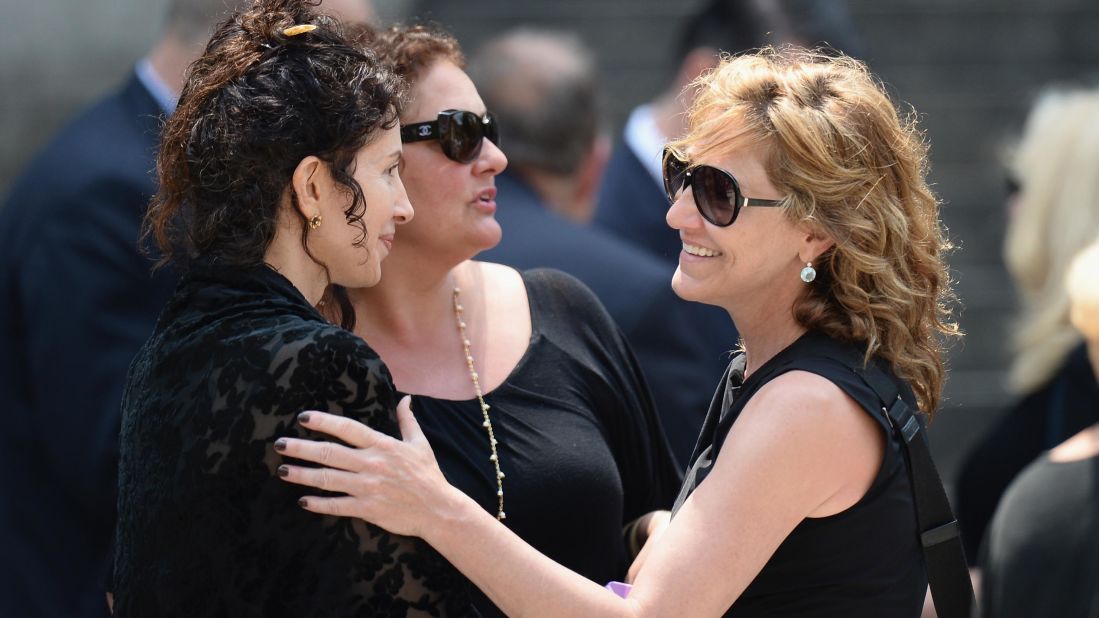 Aida Turturro, center, and Edie Falco, right, attend the funeral.