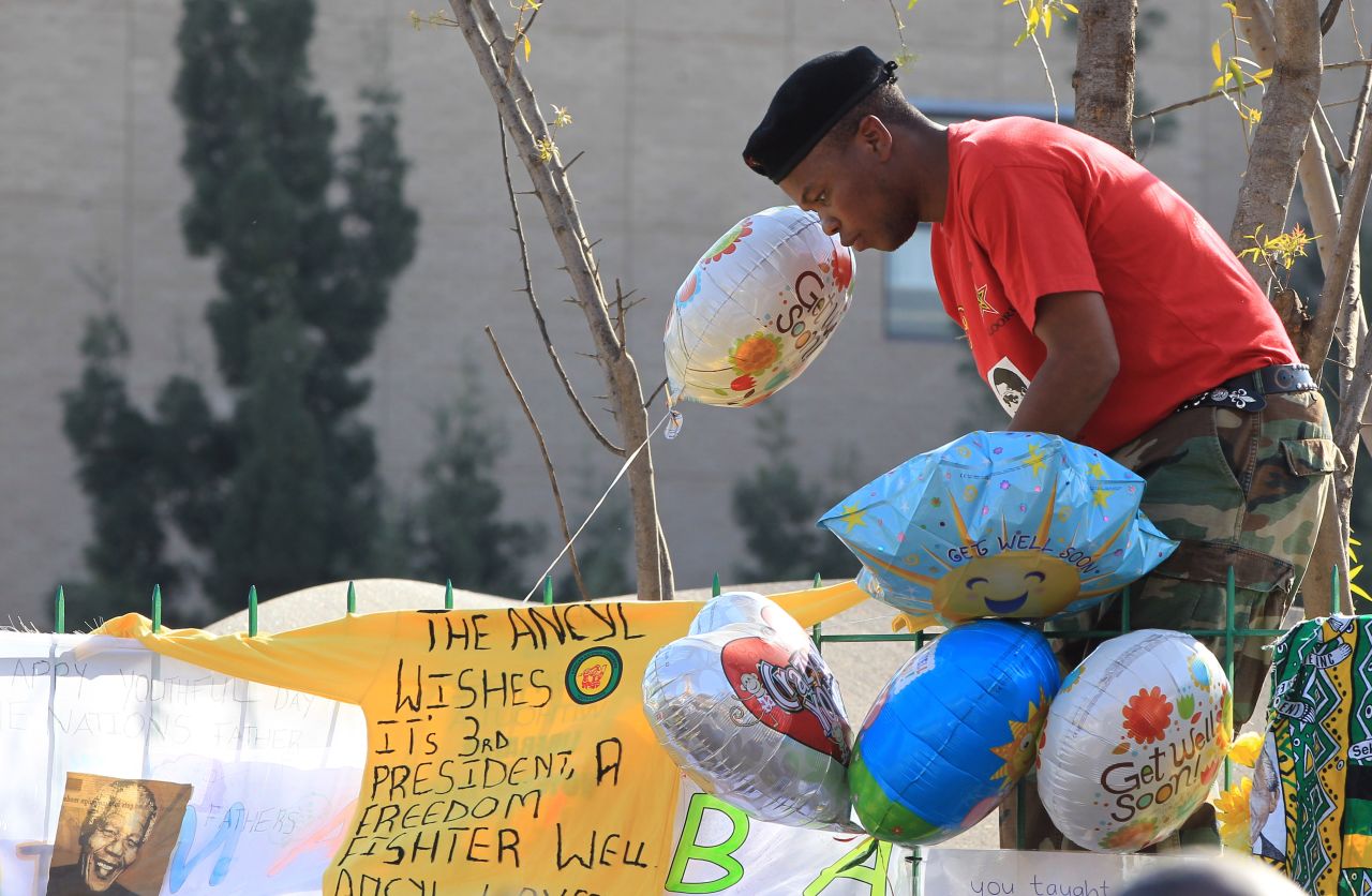 A youth league member wishes Mandela well in a banner on a fence near the hospital on June 27.