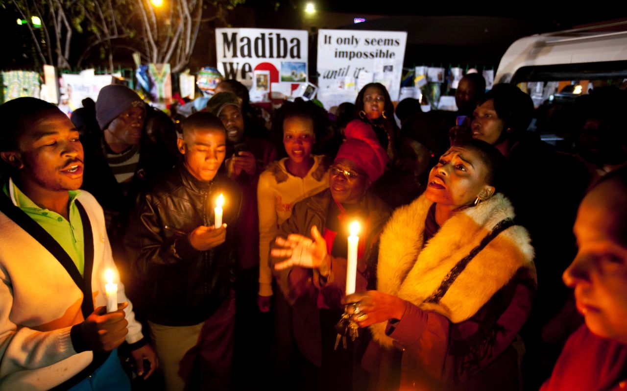 Well-wishers sing songs by candlelight outside the hospital on June 27.