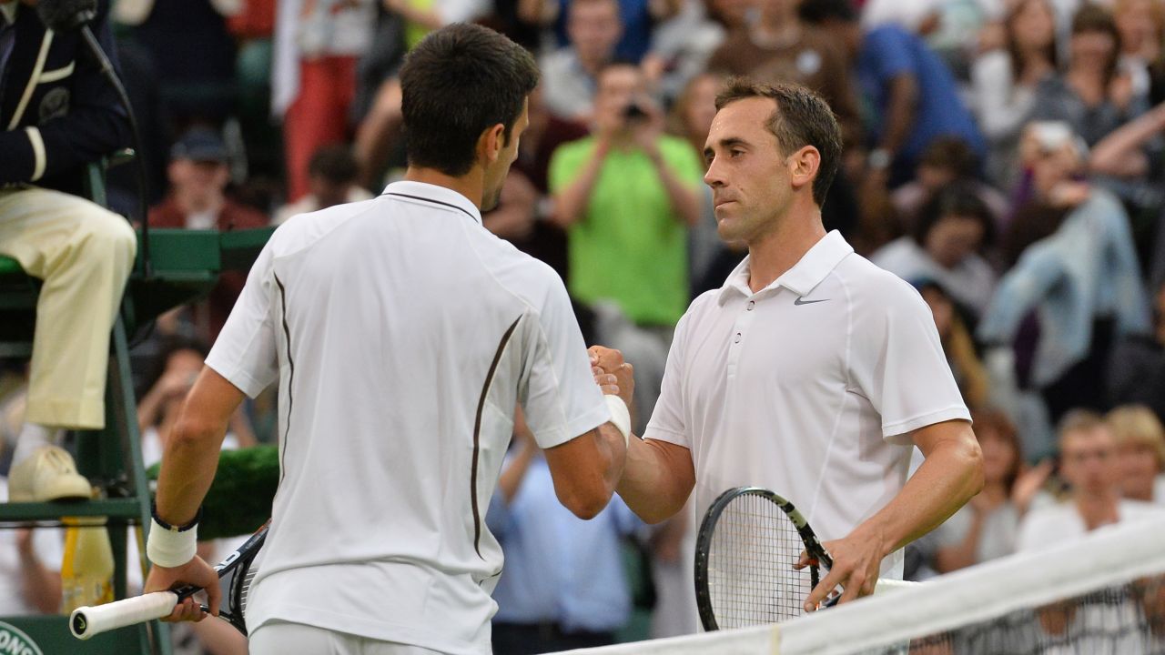 Novak Djokovic shakes hands with Bobby Reynolds, the 11th and last American to exit the men's singles. 