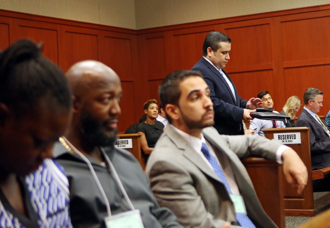 Zimmerman walks past Martin's parents, Sybrina Fulton, left, and Tracy Martin, second from left, as he enters the courtroom after lunch recess on June 26.