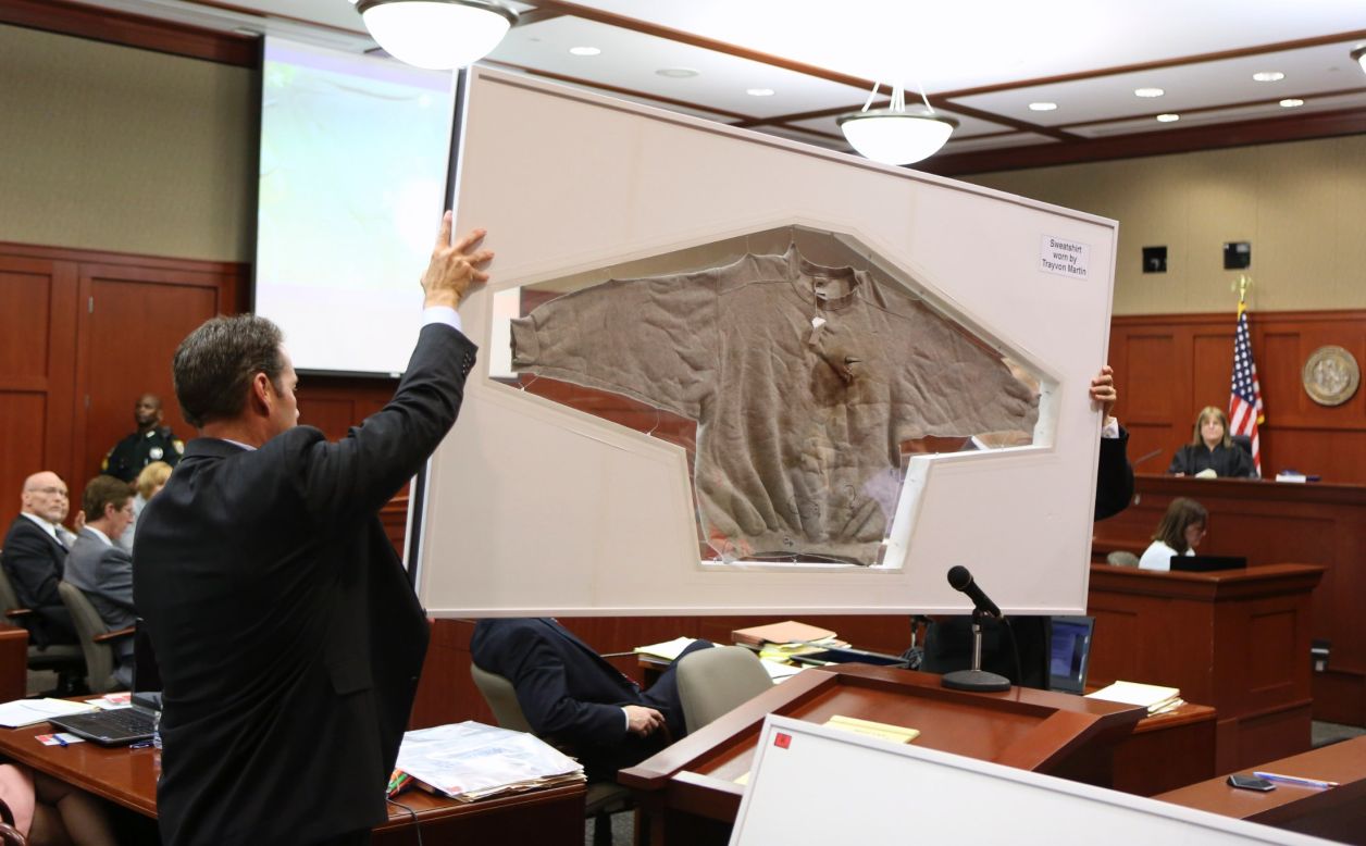 Assistant state attorneys John Guy, left, and Richard Mantei hold up Martin's sweatshirt as evidence during Zimmerman's trial on June 25. After Martin's death, <a href="http://www.cnn.com/2012/03/27/living/history-hoodie-trayvon-martin/index.html">protesters started wearing hoodies</a> in solidarity against racial profiling.