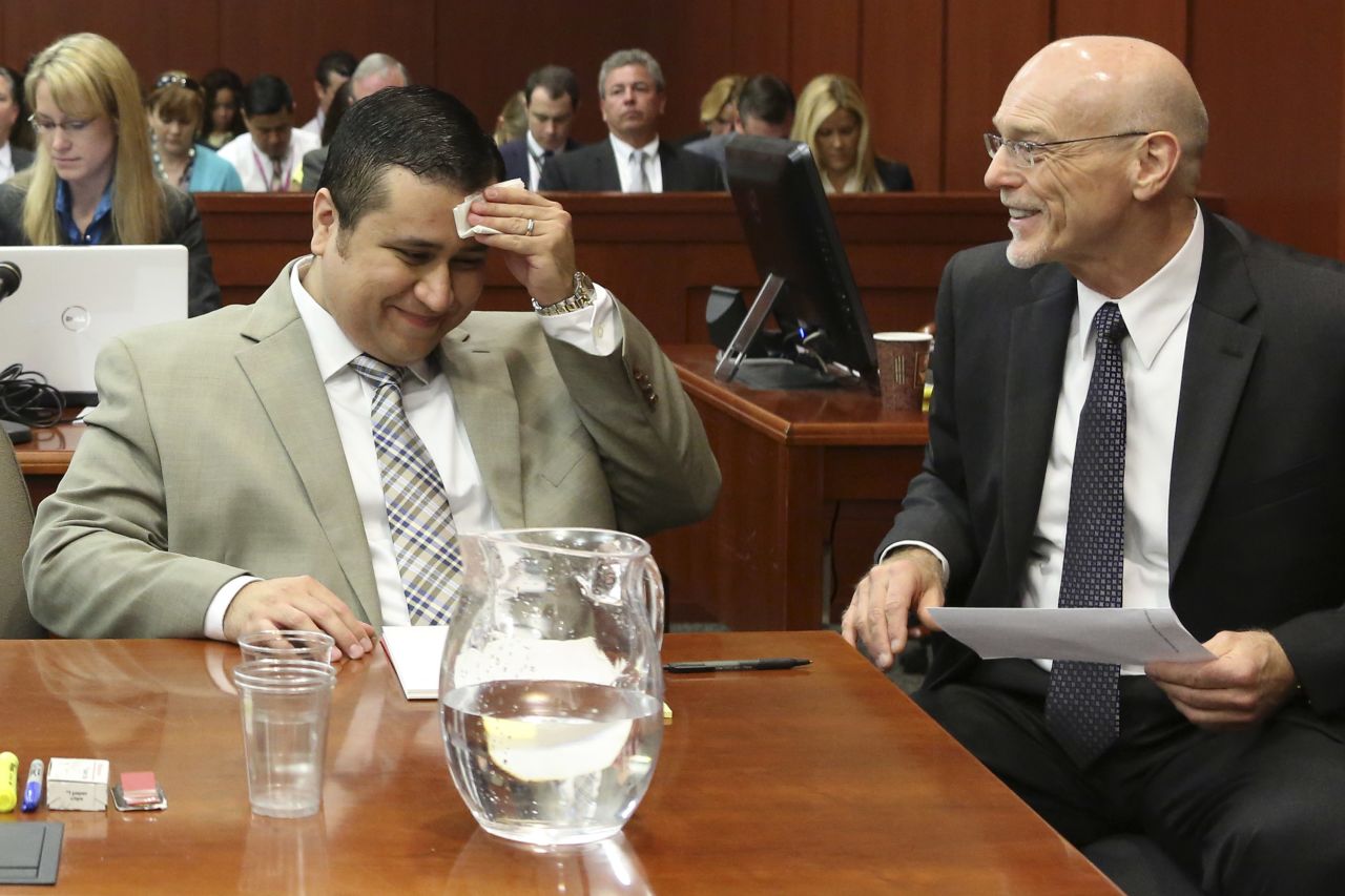 Zimmerman laughs with defense attorney Don West during his trial on June 25.