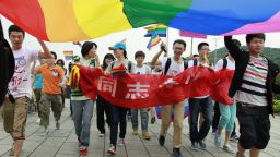 Youngsters hold a rainbow flag, a symbol for the homosexuals, as they march on the street during their anti-discrimination parade in Changsha, central China's Hunan province on May 17, 2013. About one hundred persons gathered to the anti-discrimination parade on the International Day Against Homophobia, appealing for understanding to homosexuals from the mass people. CHINA OUT AFP PHOTOSTR/AFP/Getty Images
