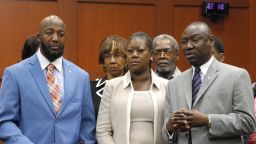 From left, Trayvon Martin's parents, Tracy Martin and Sybrina Fulton, and Benjamin Crump, the family's legal counsel, make a brief statement to the media before jurors heard opening statements on June 24.