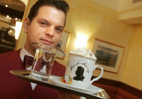 In Europe, Austria is the only country where citizenship by investment is possible, says Henley & Partners. Here, a waiter serves a coffee at 'Cafe Mozart' in the famous Getreidegasse in the city of Salzburg. 