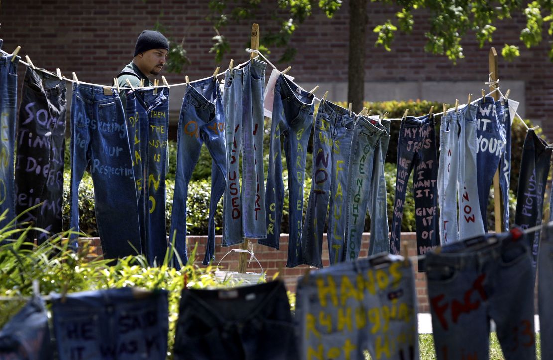 A man looks at blue jeans with messages challenging misconceptions about sexual violence on the University of California Los Angeles campus during Denim Day on April 21, 2004. In 1999, wearing jeans on Denim Day during Sexual Assault Awareness Month became an international symbol of protest against rape in response to an Italian Supreme Court decision, which overturned a rape conviction because the victim wore jeans. The justices reasoned that the victim must have helped her attacker remove her jeans because it would have been impossible without her help.