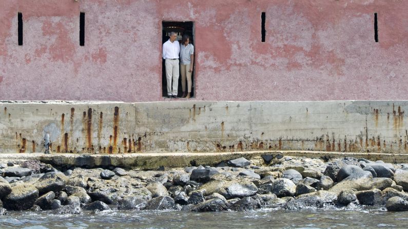 Barack and Michelle Obama look out from the Door of No Return while touring the House of Slaves at Goree Island off the coast of Dakar, Senegal, on Thursday, June 27.