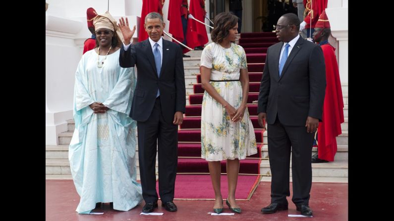 Senegal's President Macky Sall, right, and Sall's wife, Marieme Faye Sall, left, welcome the president and first lady as they arrive at the presidential palace prior to meetings in Dakar on June 27.