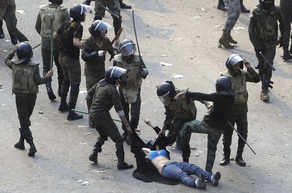 Egyptian army soldiers beat a young woman during a protest at Tahrir Square in Cairo on December 17, 2011. The shocking image of the "blue bra girl" <a href="http://www.cnn.com/2011/12/22/opinion/coleman-women-egypt-protest/index.html">became a symbol of the oppression </a>and a rallying cry for several thousand Egyptian women.