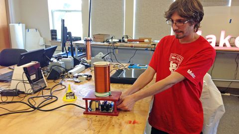 Brian Melani, an engineering intern at Maker Media, demonstrates a mini-Tesla coil, or electrical circuit. The test project could end up as a project in a future issue of Make magazine. 