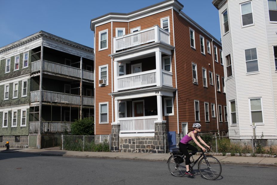 A lone cyclist rides by the apartment building where Renata lives in Boston.