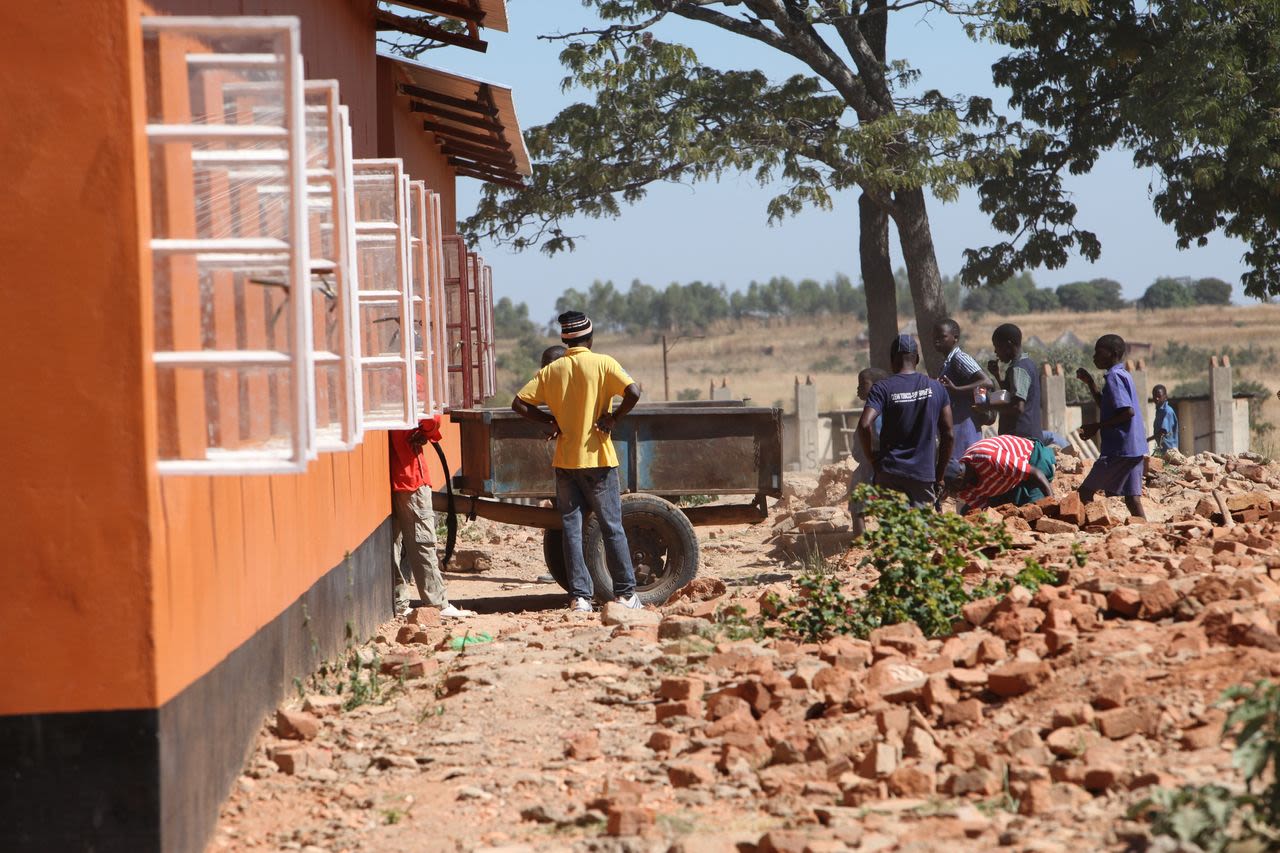 The community in Matau has helped rebuild the school, molding nearly 400,000 bricks for the new building.