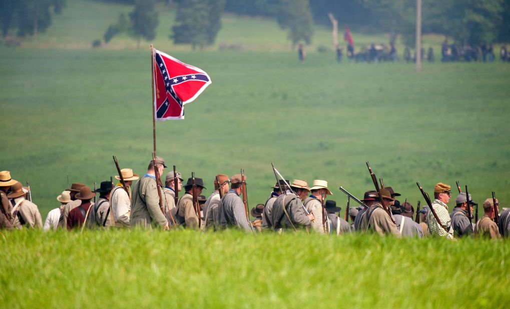 Confederate troops move into position during a reenactment of the Battle of Gettysburg on June 28. The event is taking place at Bushey Farm, outside park property.