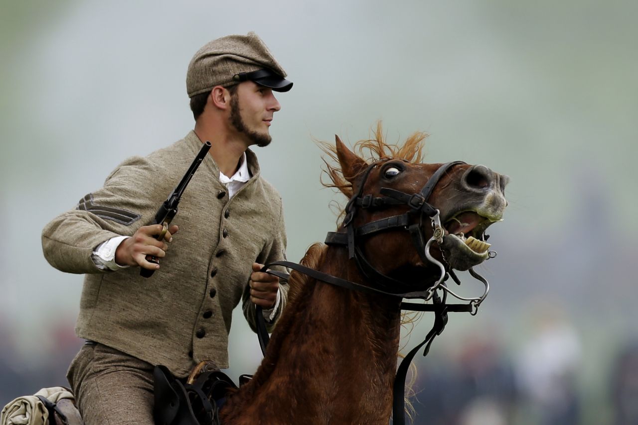 A mounted Confederate reenactor takes part in a demonstration. Besides portrayals of the fighting, the reenactment includes about 200 individuals representing the townspeople of Gettysburg in 1863.