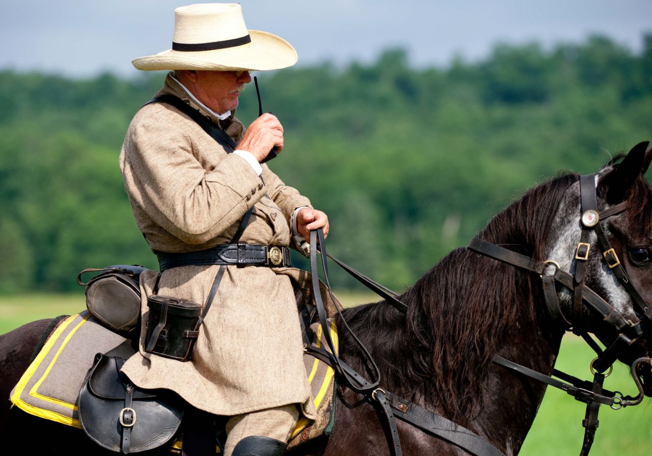 In a rare concession to non-period technology, a Confederate officer speaks into his walkie-talkie to position his troops during a reenactment.