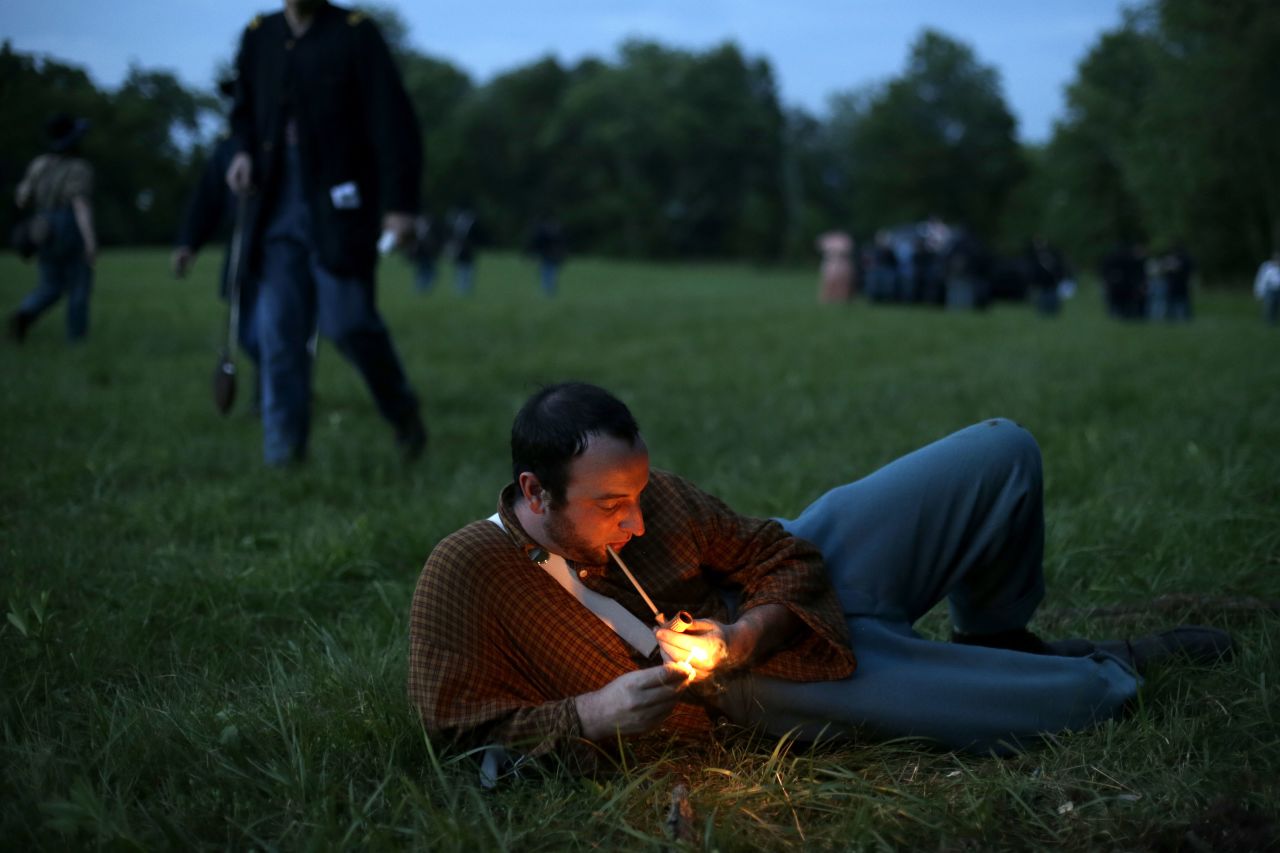 A Union soldier with Murray's Brigade lights his pipe at Bushey Farm in Gettysburg on Thursday, June 27.  