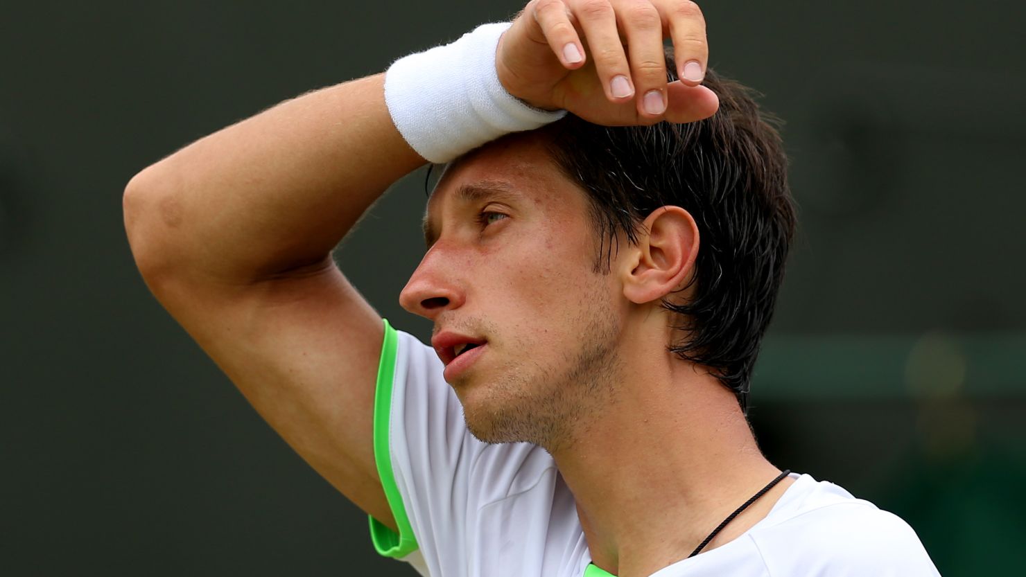 A dejected Sergiy Stakhovsky on his way to defeat against Austria's Jurgen Melzer in their third round match at Wimbledon.