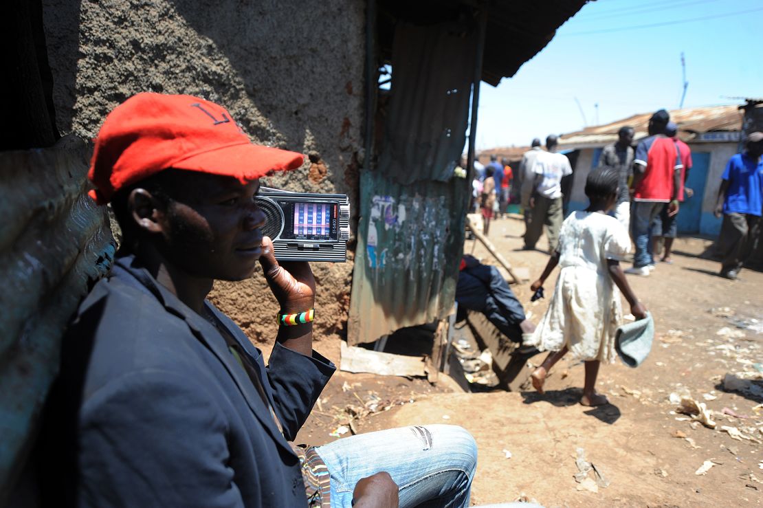 A man listens to a radio in the huge Kibera slum in Nairobi, Kenya, where Kennedy Obede grew up.