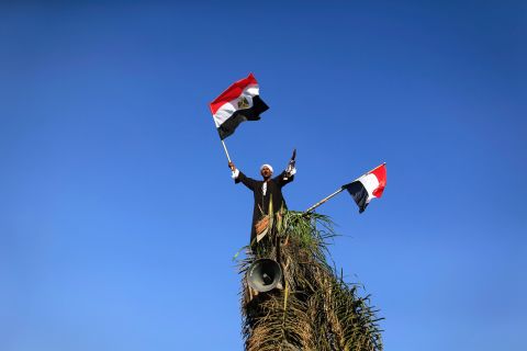 A Morsy opponent waves Egyptian flags during a protest outside the Egyptian Defense Ministry in Cairo on June 28.