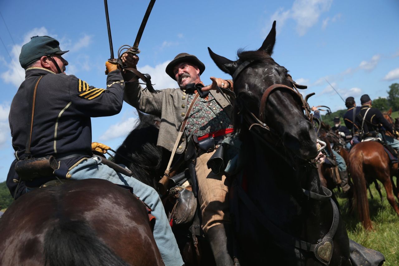 Union and Confederate actors skirmish during a re-enactment of the Battle of Gettysburg on Saturday, June 29.