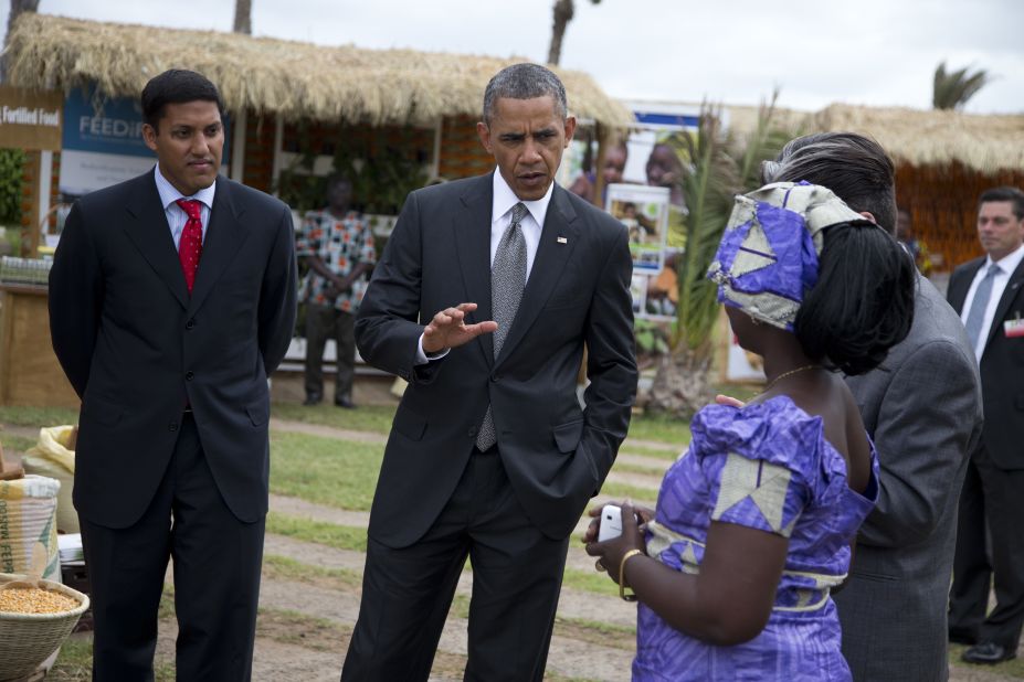 USAID administrator Rajiv Shah, left, looks on as Obama talks to Nimna Diayte, president of the Farmers Federation, during a food security expo on Friday, June 28, in Dakar, Senegal. Obama met with farmers, innovators, and entrepreneurs whose new methods and technologies are improving the lives of smallholder farmers throughout West Africa.