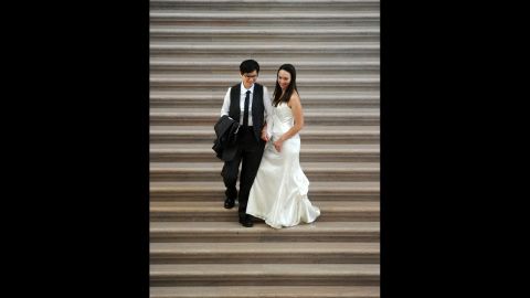 Diane Meier, left, and Julie Thompson walk down the grand staircase at San Francisco City Hall after getting married on June 29.