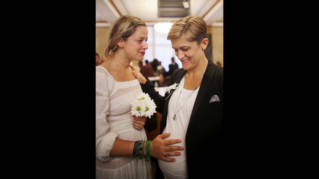 Stefanie Berks, left, touches her pregnant partner, Daisy Boyd, before their marriage at the Manhattan Marriage Bureau in New York on June 28.