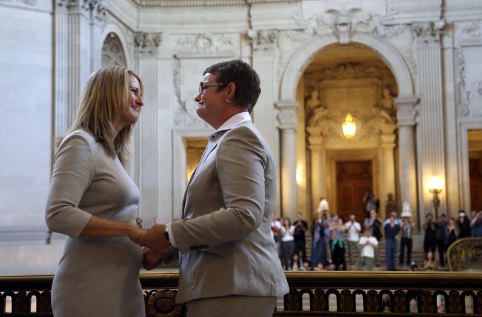 Sandy Stier, left, exchanges wedding vows with Kris Perry during a ceremony presided over by California Attorney General Kamala Harris at City Hall in San Francisco on Friday, June 28. Stier and Perry were two of the four lead plaintiffs in the U.S. Supreme Court case that overturned California's same-sex marriage ban.