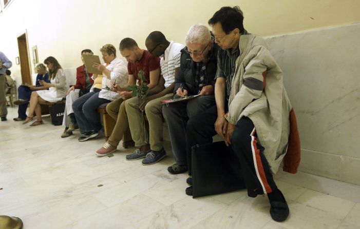 Couples fill out license applications as they wait in line at the San Francisco City Hall on June 28.
