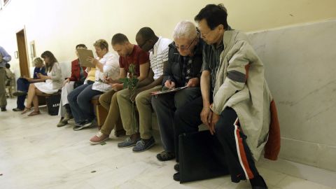 Couples fill out license applications as they wait in line at the San Francisco City Hall on June 28.
