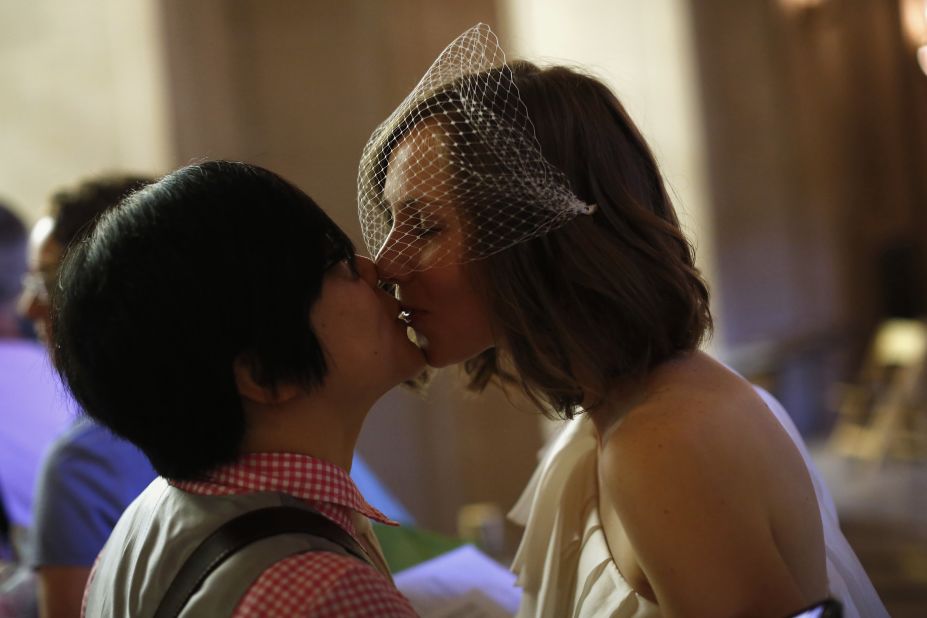 Ky Choi, left, and Ashlee Meyer kiss before getting married on June 29.
