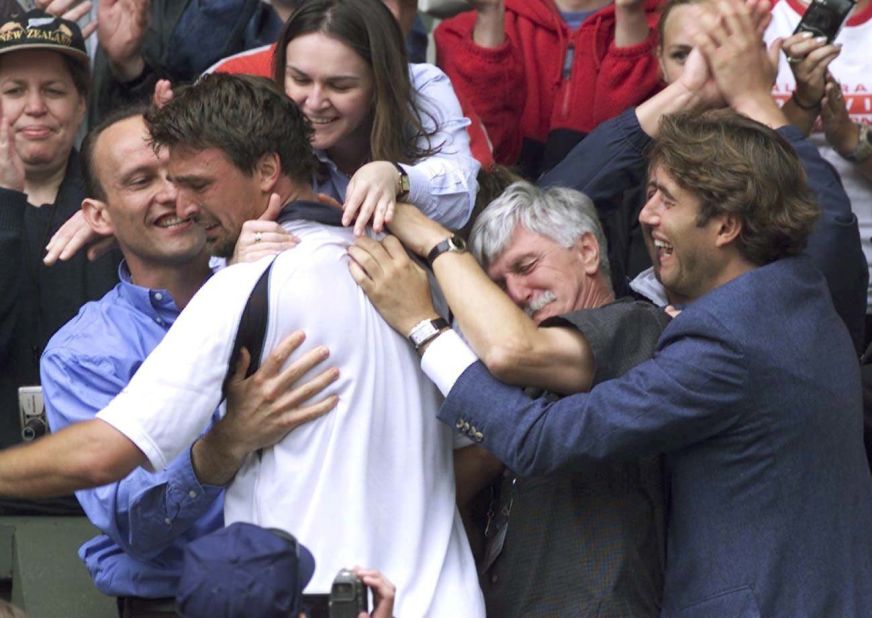 Ivanisevic climbed into his players' box to celebrate with his team, which included his father Srdjan, second from right. Srdjan had recently undergone heart surgery. 