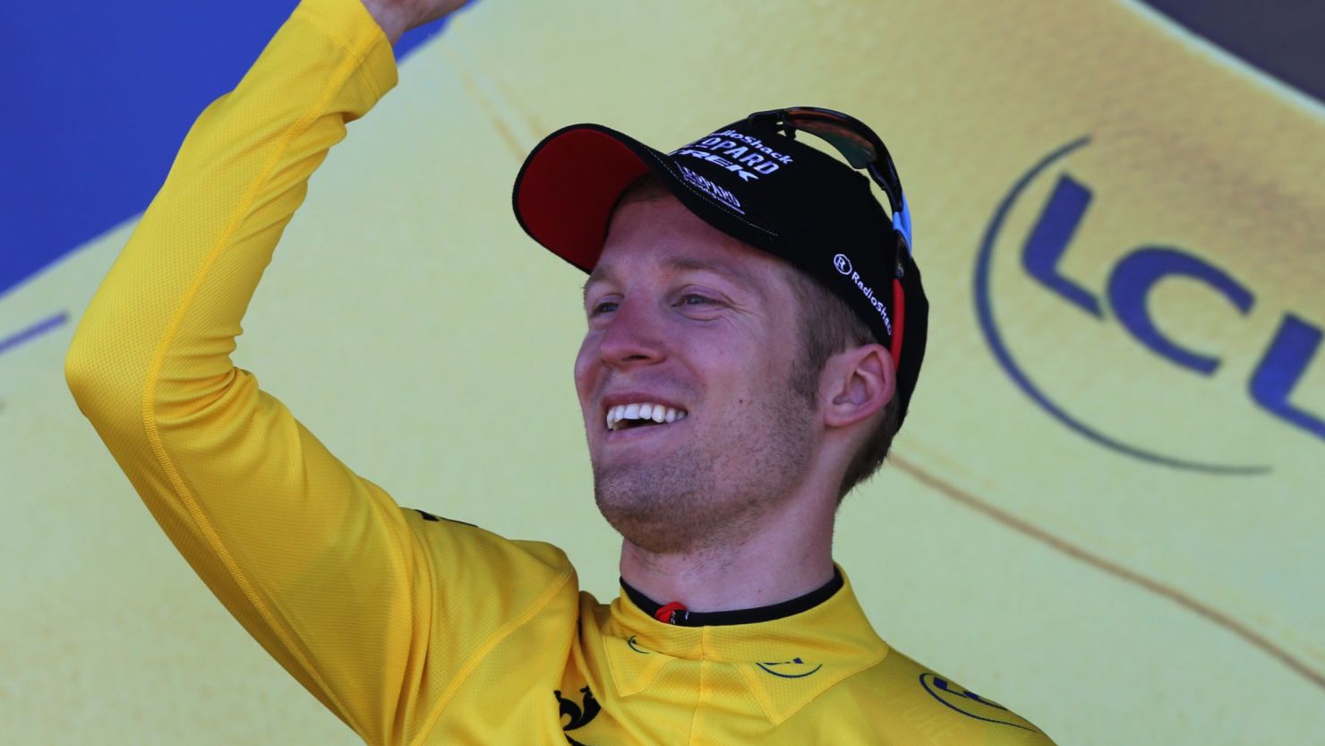 Jan Bakelants dons the yellow jersey after winning the second stage of the Tour de France in Ajaccio.
