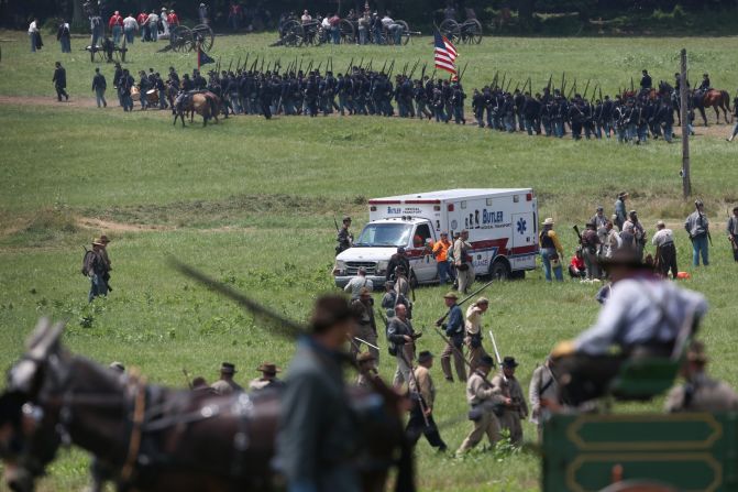 An ambulance, taking several people away due to heat exhaustion, departs the area on June 30. 