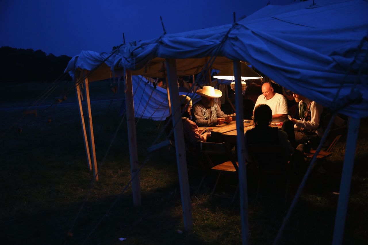 Reenactors play poker while on break during the three-day event on June 29.