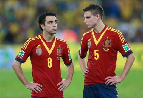 Spain's Xavi and Cesar Azpilicueta of Spain appear dejected in defeat.