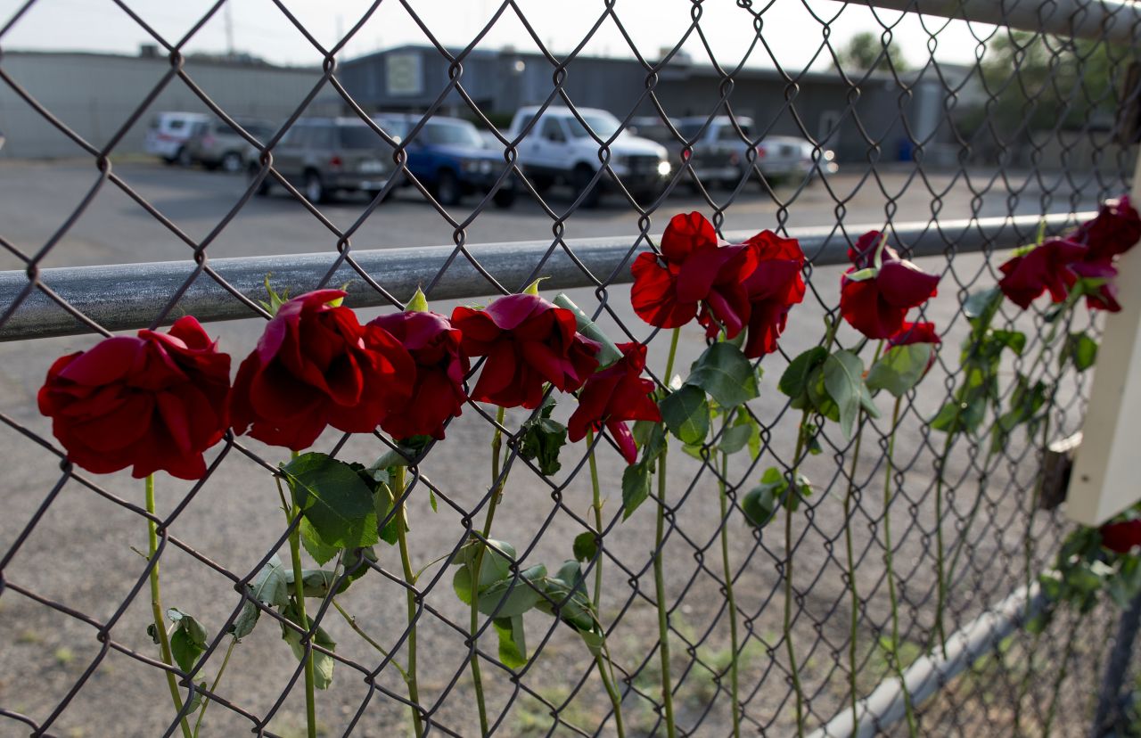 Flowers hang on the fence outside the Granite Mountain Hot Shot Crew fire station on July 1.