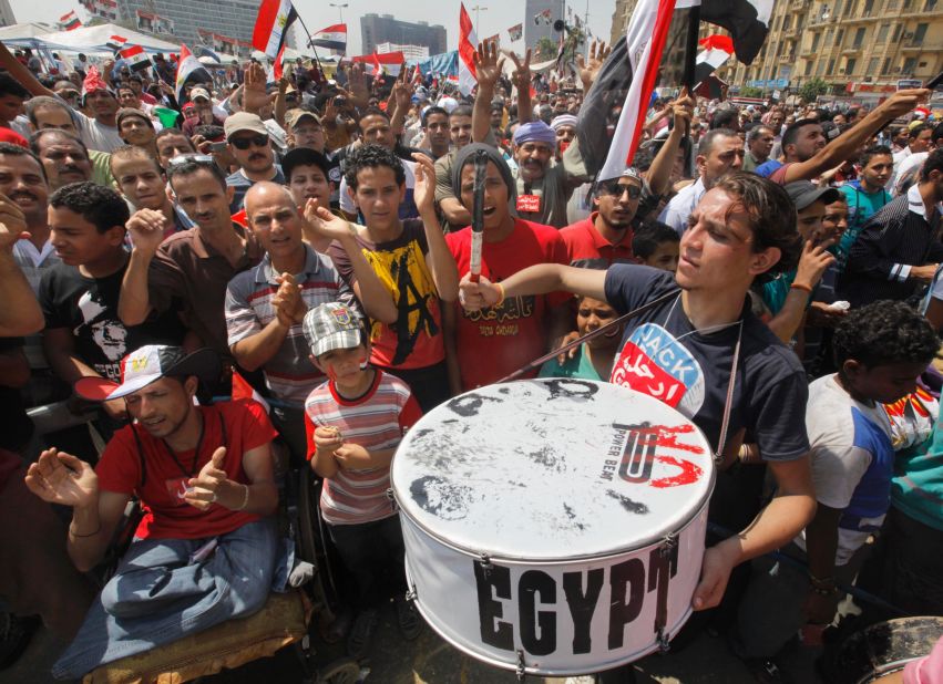 Egyptian protesters shout slogans and wave national flags during a demonstration against President Mohamed Morsy in Tahrir Square in Cairo on July 1. 