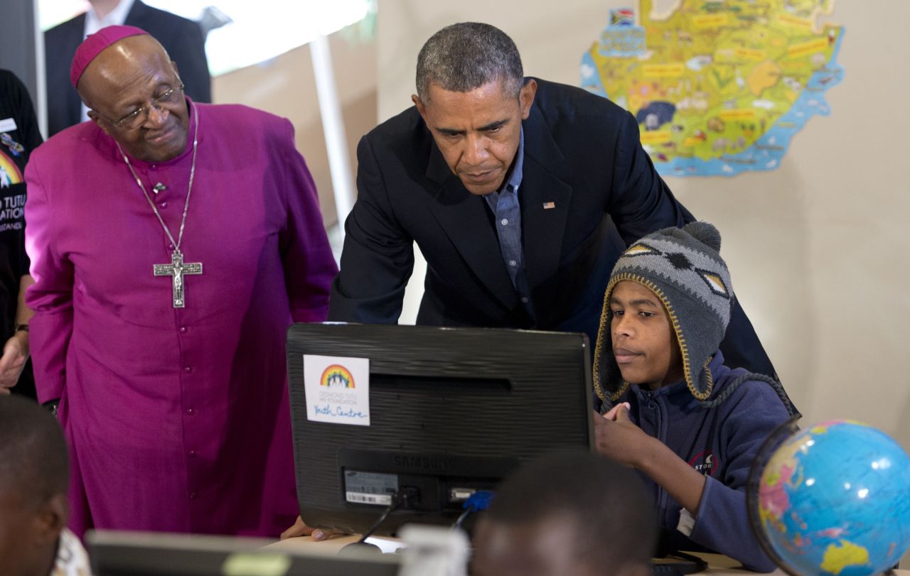 Obama visits the Desmond Tutu HIV Foundation Youth Centre with Nobel peace laureate Archbishop Desmond Tutu and 15-year-old Aviwe Mtongana in Cape Town on June 30.