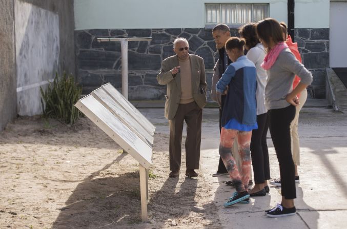 Ahmed Kathrada, a former fellow prisoner with Nelson Mandela, shows the Obama family around Robben Island in Cape Town, South Africa, on Sunday, June 30. The island, where prisoners were banished and isolated during the apartheid era, is now a museum.