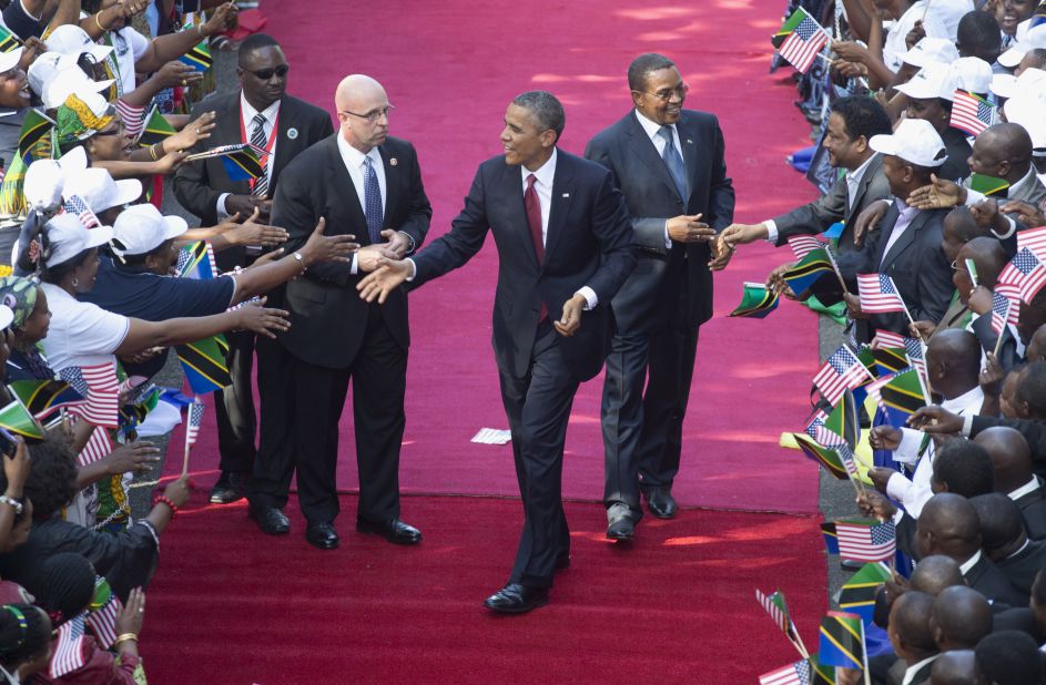 Obama and Kikwete, right, are greeted by a cheering crowd as they arrive at the State House in Dar es Salaam, Tanzania, on Monday, July 1.