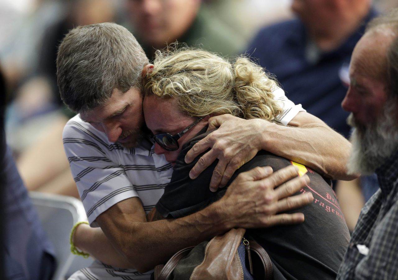 A couple embraces during the Prescott memorial service for the fallen fighters on July 1. <a href="http://www.cnn.com/2013/07/02/us/gallery/hot-shot-victims/index.html">The elite team members' deaths</a> on Sunday, June 30, marked the deadliest day for firefighters since the 9/11 attacks.