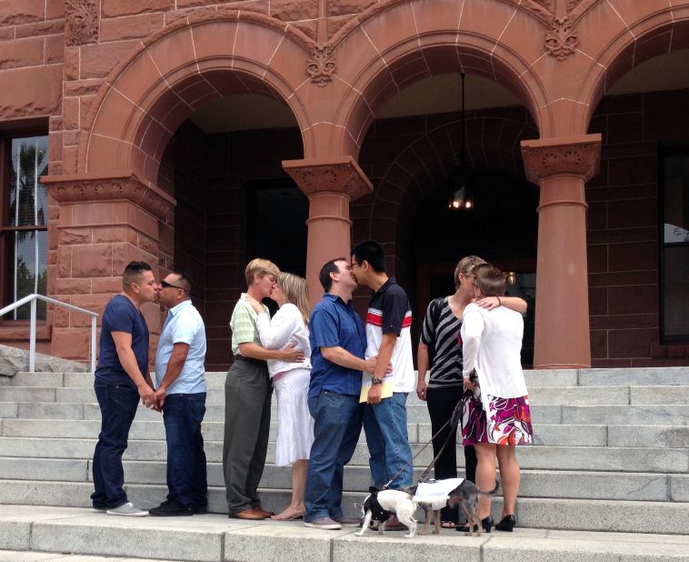 Same-sex couples kiss on the steps of the the Old Orange County Courthouse in Santa Ana, California, on July 1.