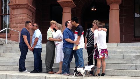 Same-sex couples kiss on the steps of the the Old Orange County Courthouse in Santa Ana, California, on July 1.