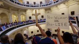 Supporters on both sides of the issue crowd into the rotunda of the state Capitol on July 1.